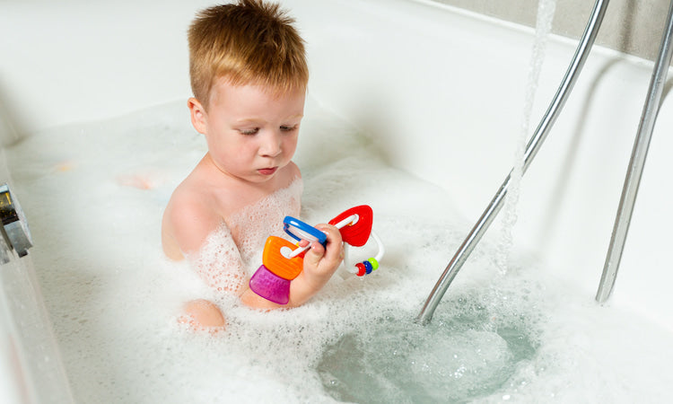 Baby in a bathtub with toy