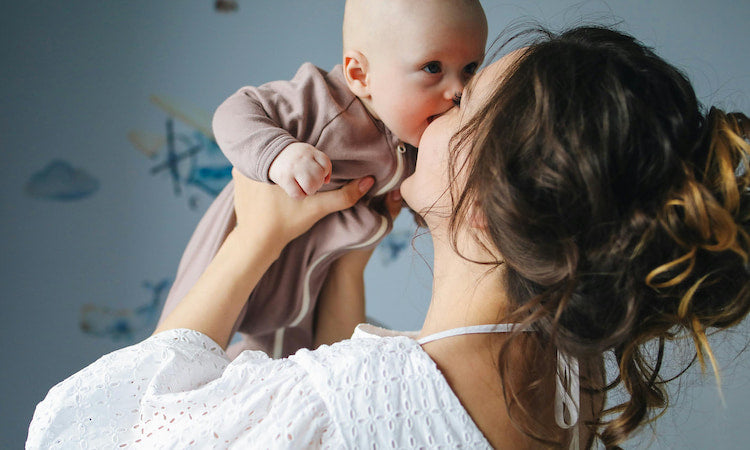 Mom playing with newborn baby