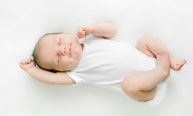 Newborn smiling in sleeping